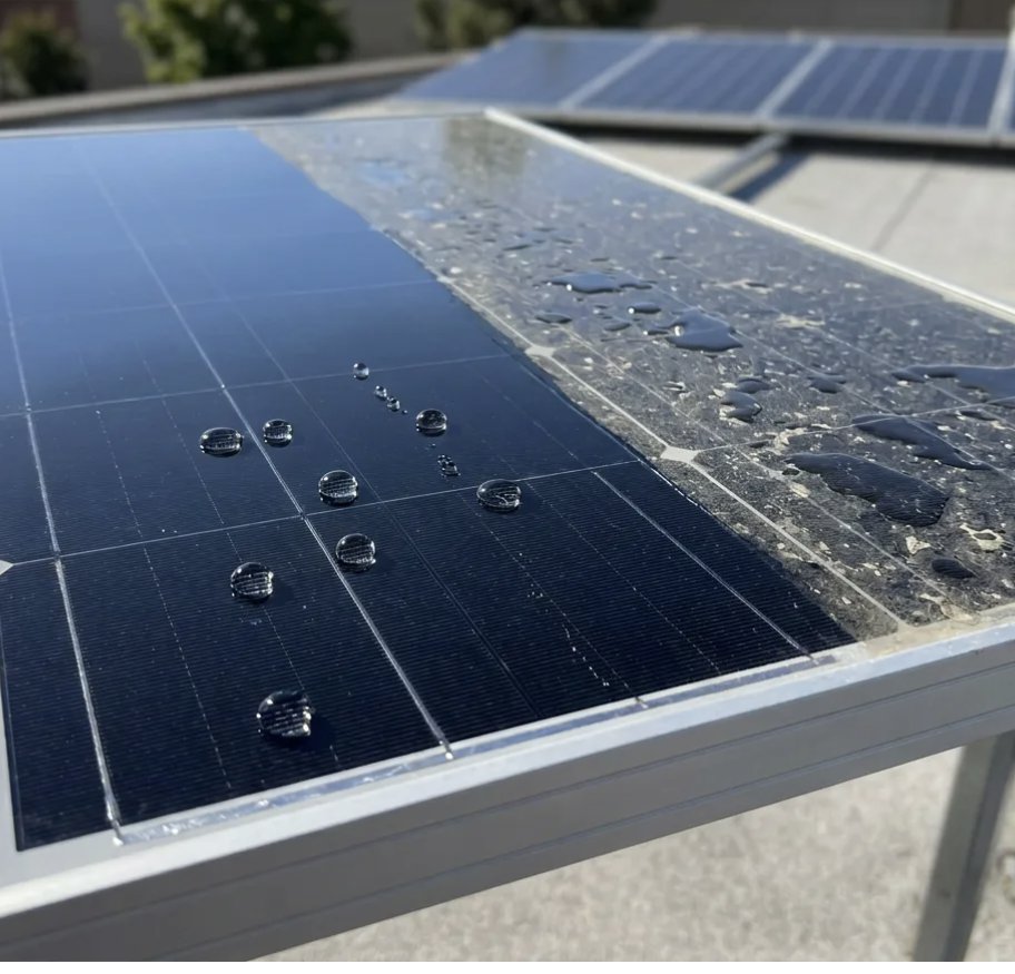 A solar panel in daylight, tight beads of water on the coated half and sheeted water with debris on the uncoated half.
