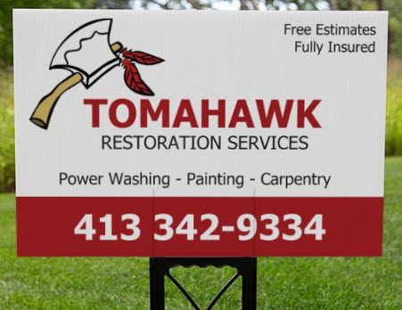 Tomahawk yard sign staked in a lawn.